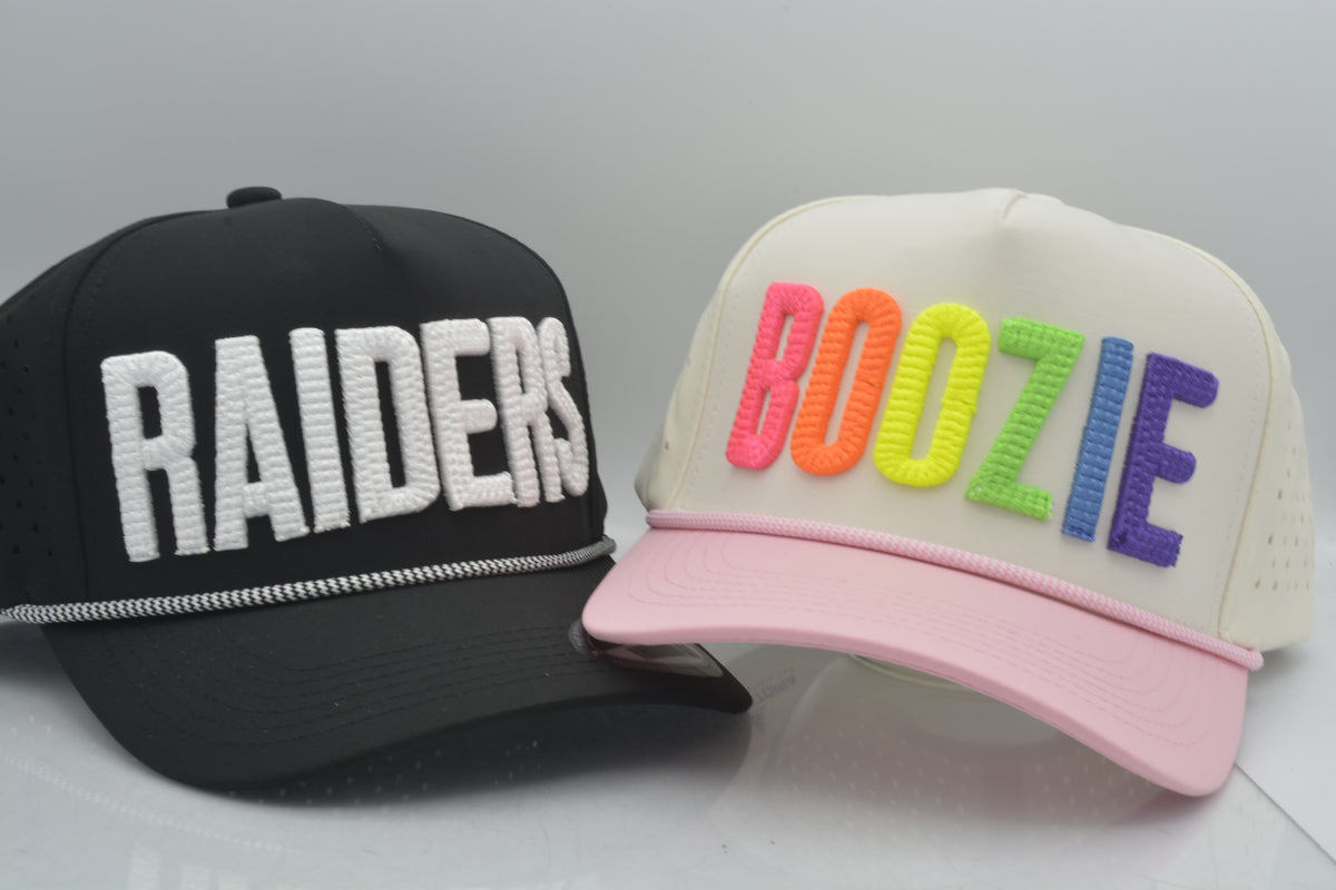 embroidered puffy text on performance caps